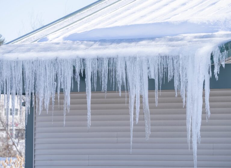 winter house with icicle and snow on the roof